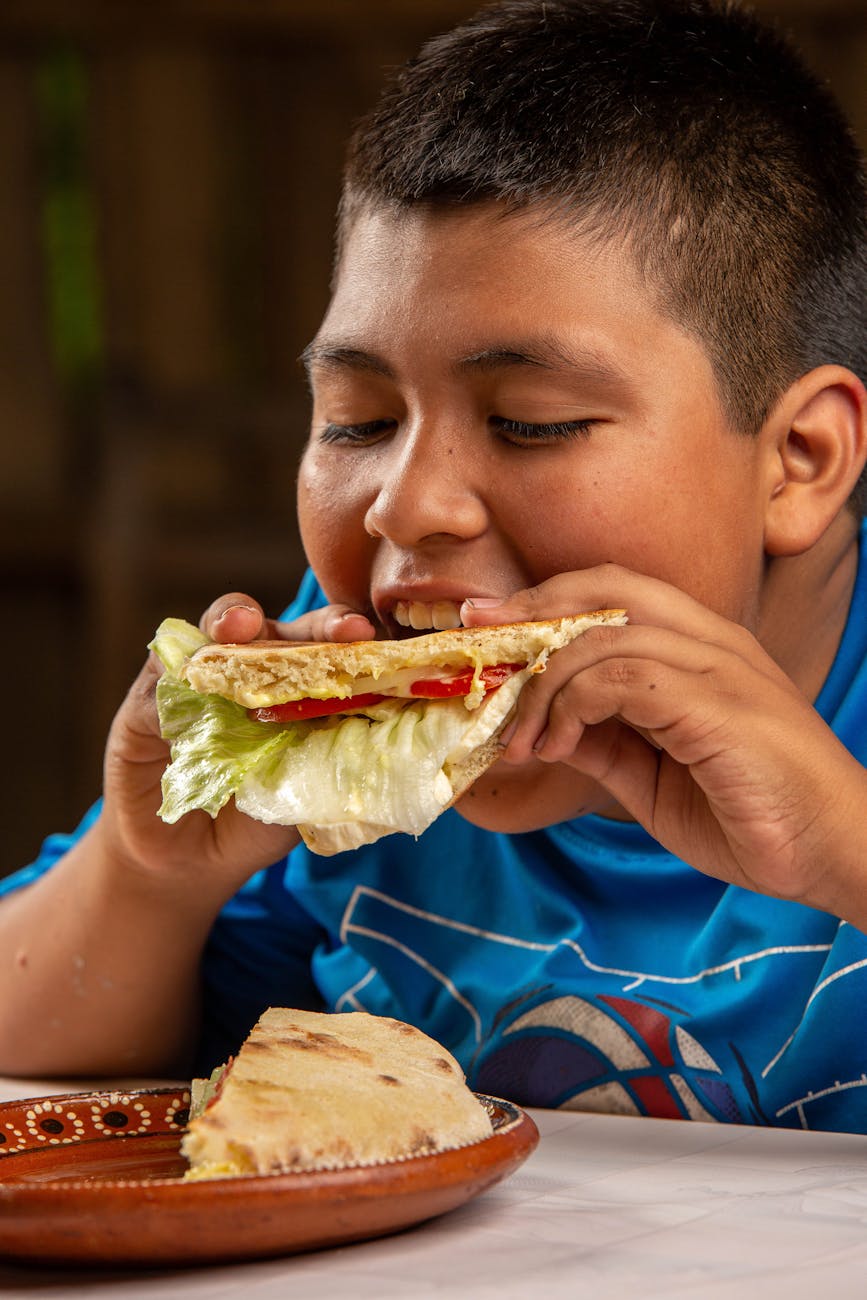 young boy eating pita